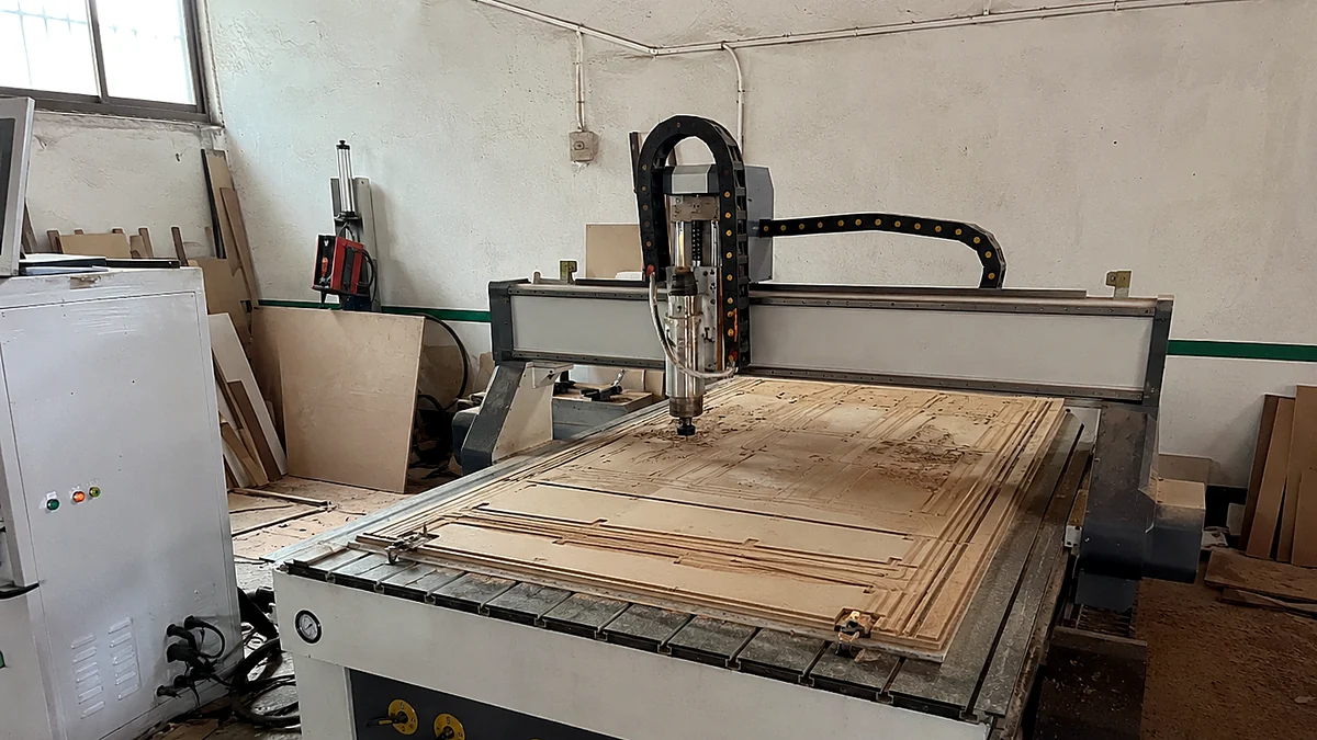 CNC woodworking router machine with carved wood panel